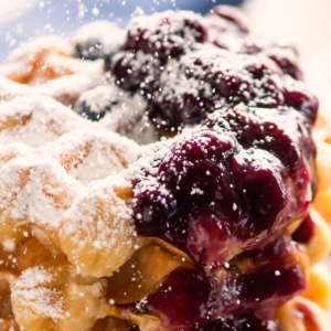 blueberry compote on stack of small waffles